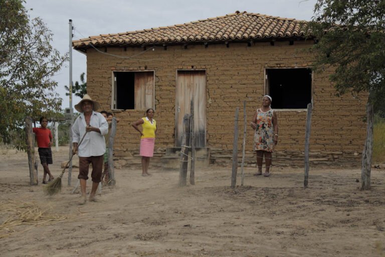 A family of Baixões residents outside their home.